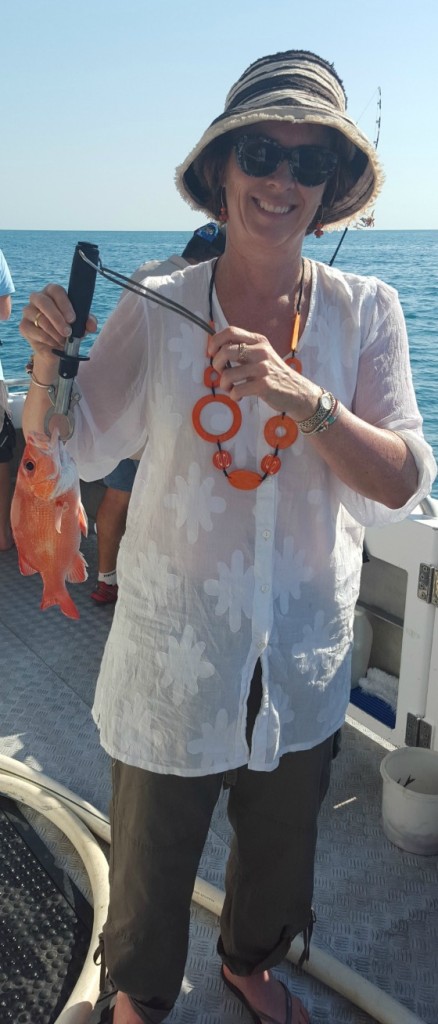 Jen catches her first deep sea fish - which just happens to match the necklace!