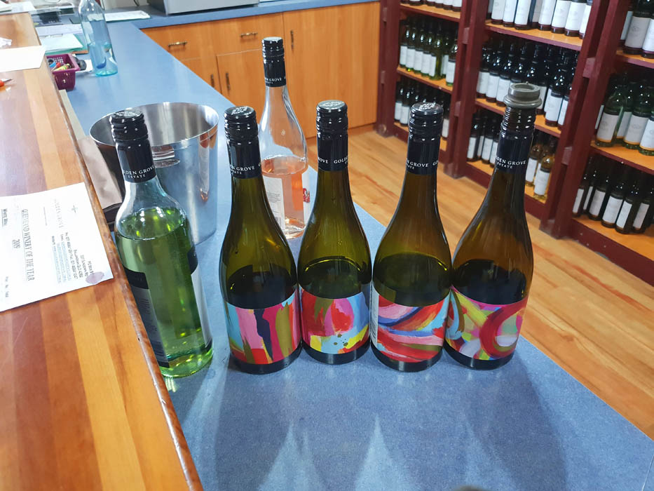 Image showing four bottles of wine on a bench all with brightly coloured labels