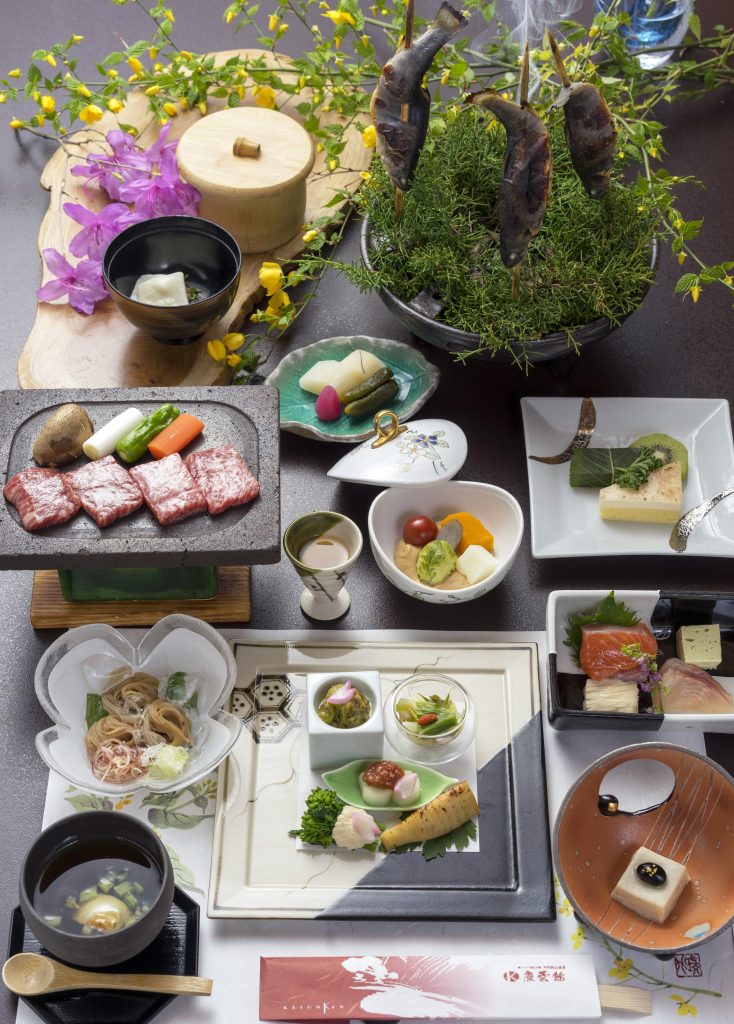 Image of a selection of small plates and dishes covered in decorative food in typical Japanese style