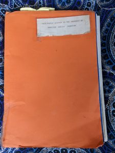 Image of an orange manila folder with a white sticky label in the top right corner that says this Family history is the property of Jennifer Johnston