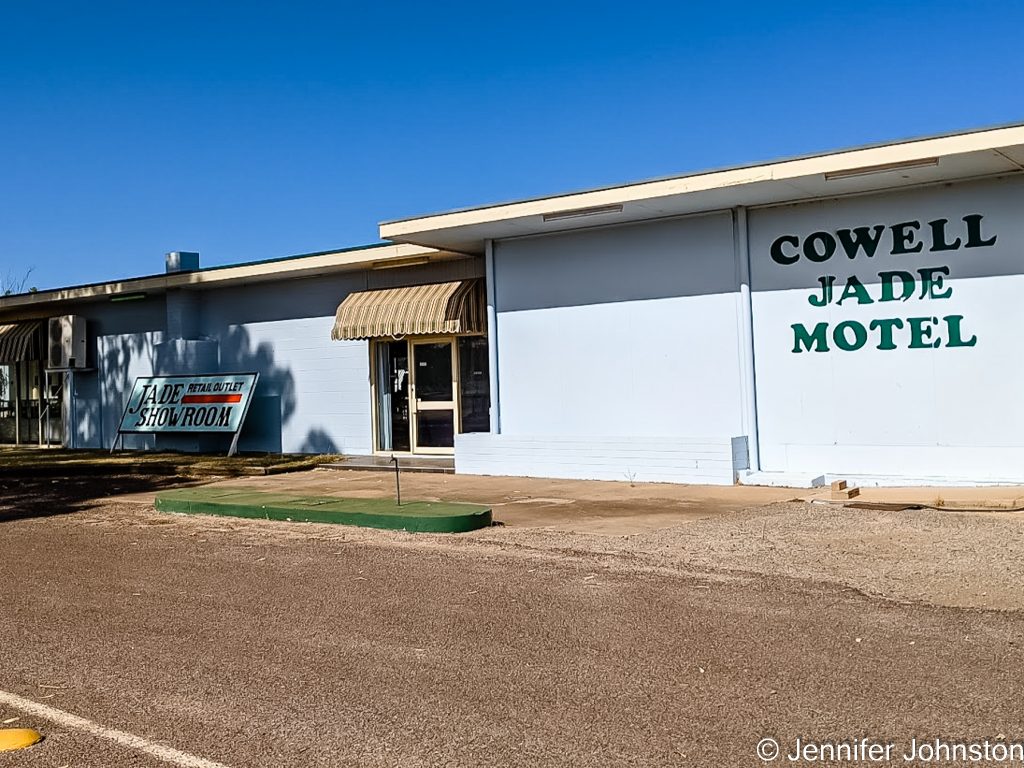 Image of a motel painted a pale blue with the words Cowell Jade Motel