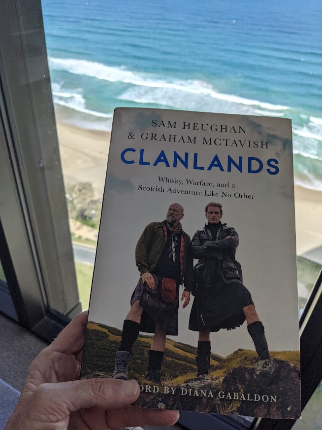 Front cover of a book with the words Clanlands on the front and a photo of two men on the cover wearing kilts