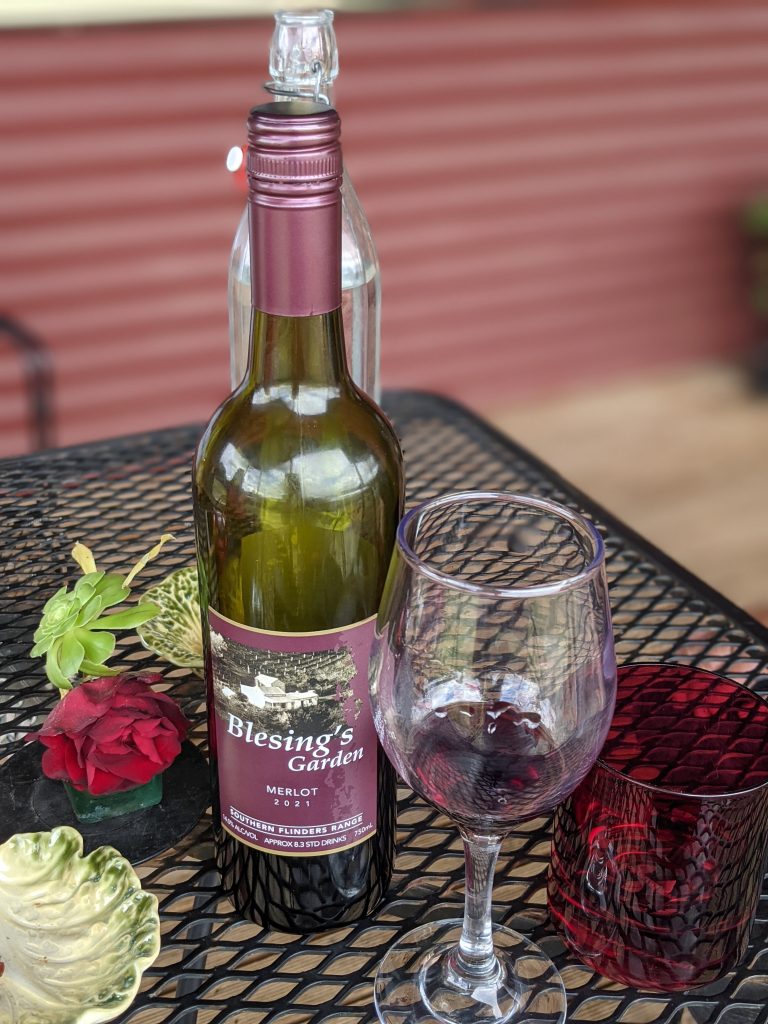 Image of wine bottle and a wine glass on a table