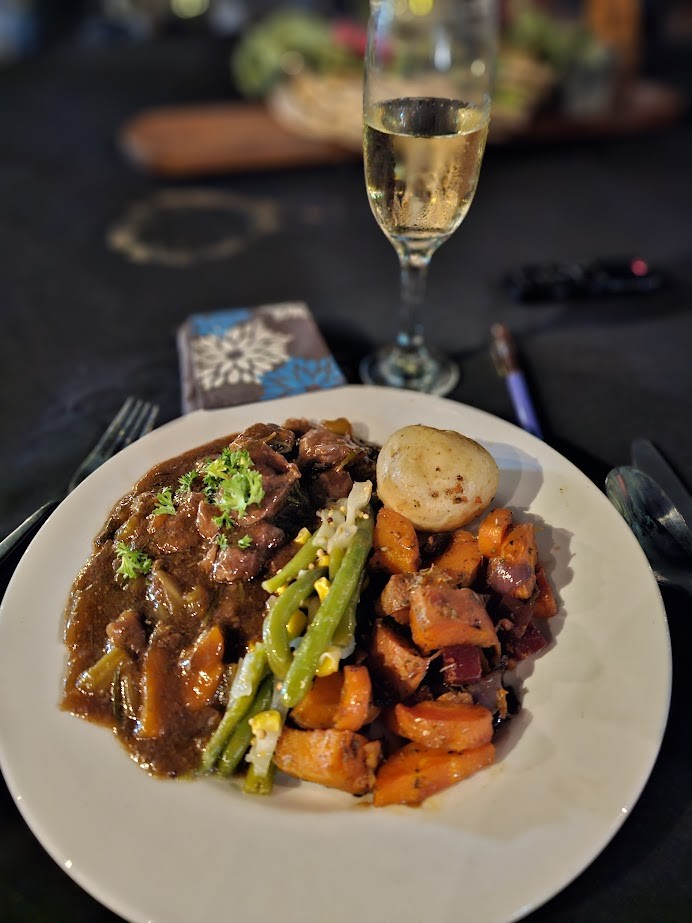 Image of a plate of food with lamb stew and lots of vegetables