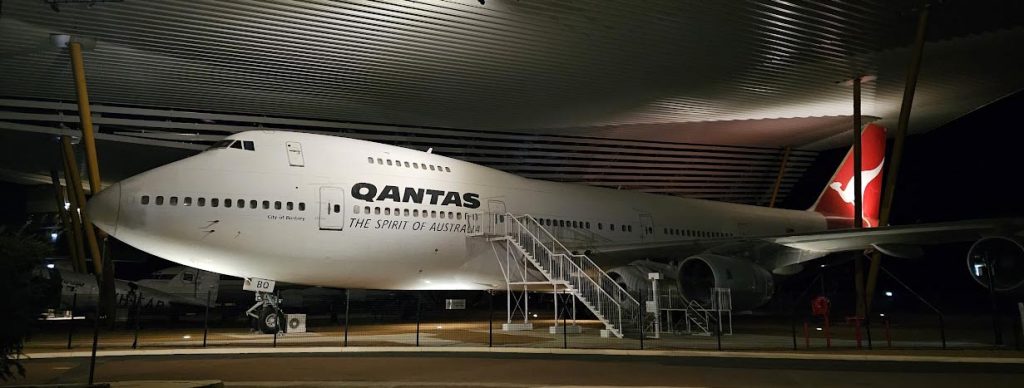 Image of a Qantas plane underneath a large roof